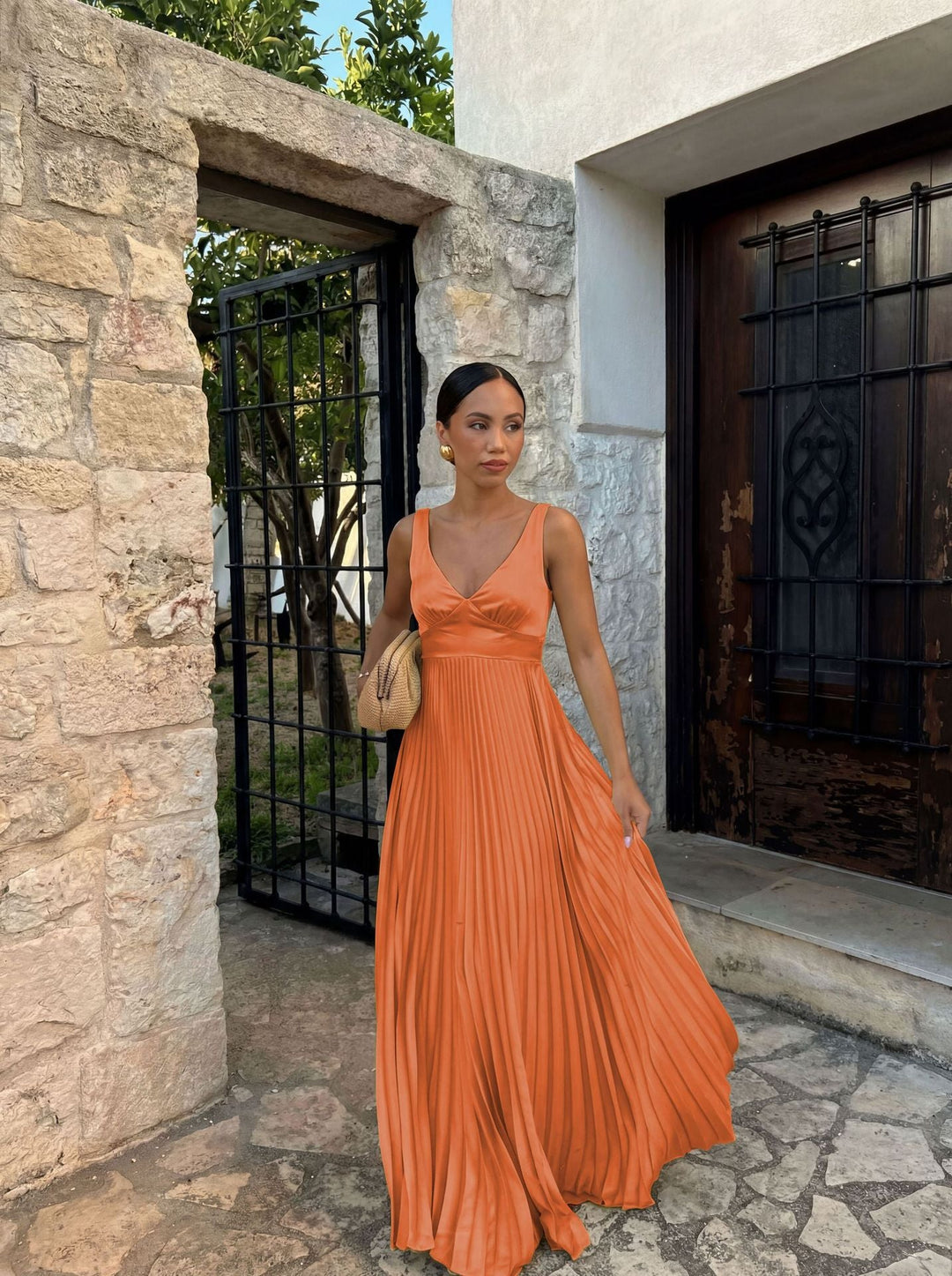 Lightweight women's pleated V-neck dress. Chic sleeveless design, perfect for warm weather occasion wear.