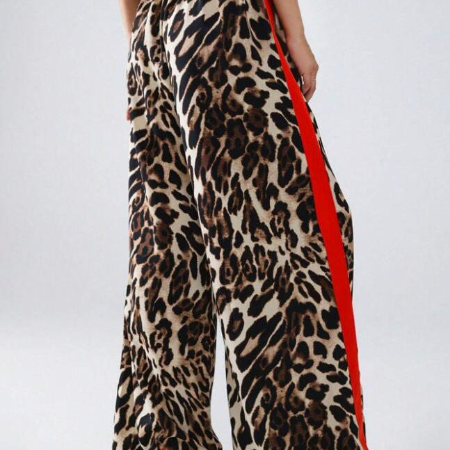 Women's chic leopard print wide-leg pants with stylish black stripe detail. Comfortable & trendy fashion bottoms.