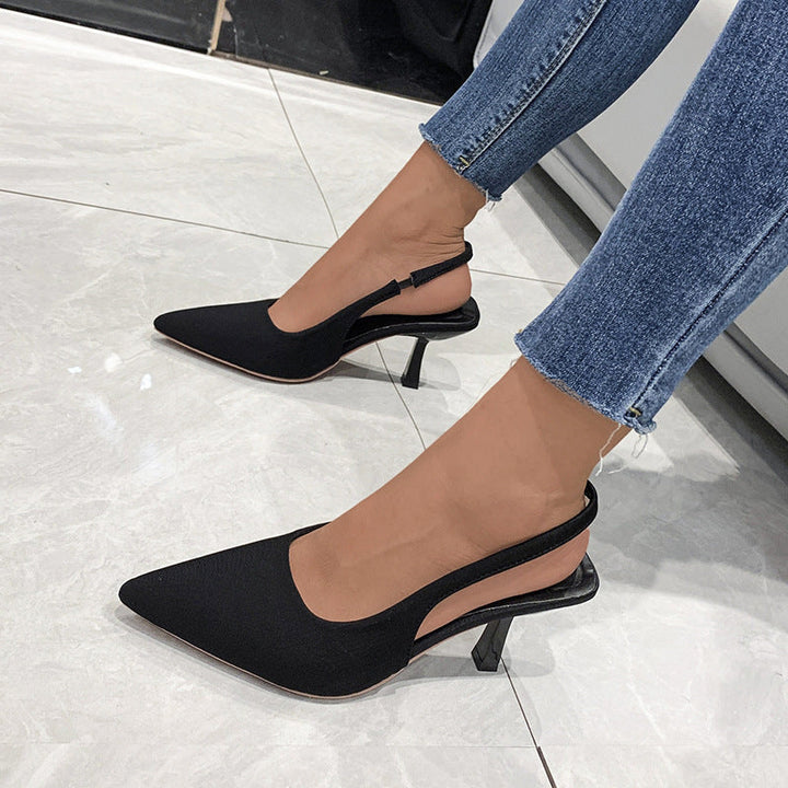 Fashionable women's black pointed-toe slingback heels, ideal for elegant office or evening wear.