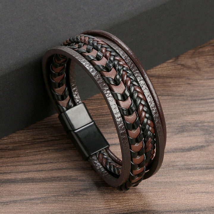 Men's wrist wearing a braided leather Viking bracelet, showcasing a rugged style.