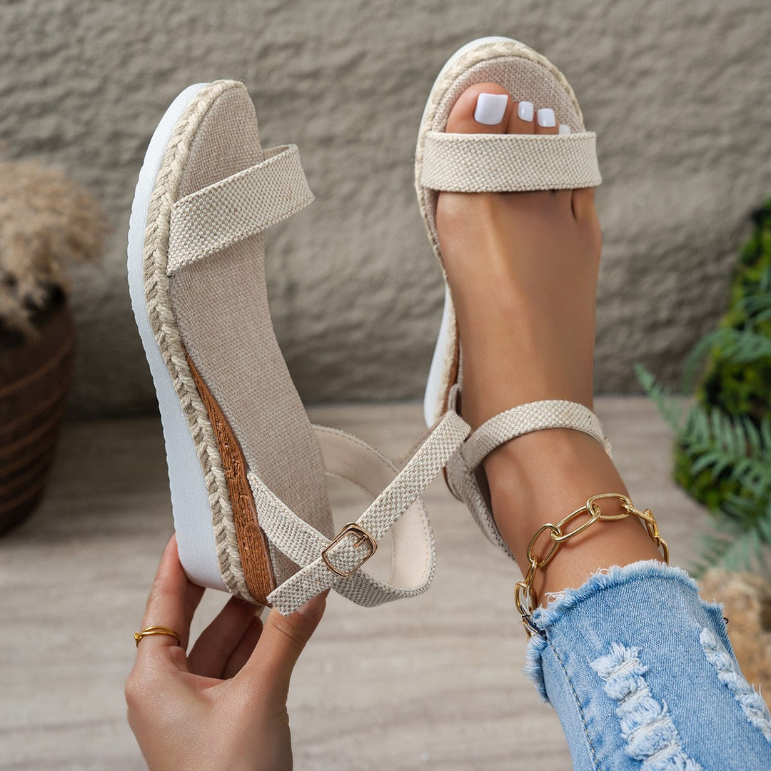 Chic women's beige wedge sandals with elegant strap, woven accents & espadrille heel. Versatile summer footwear.