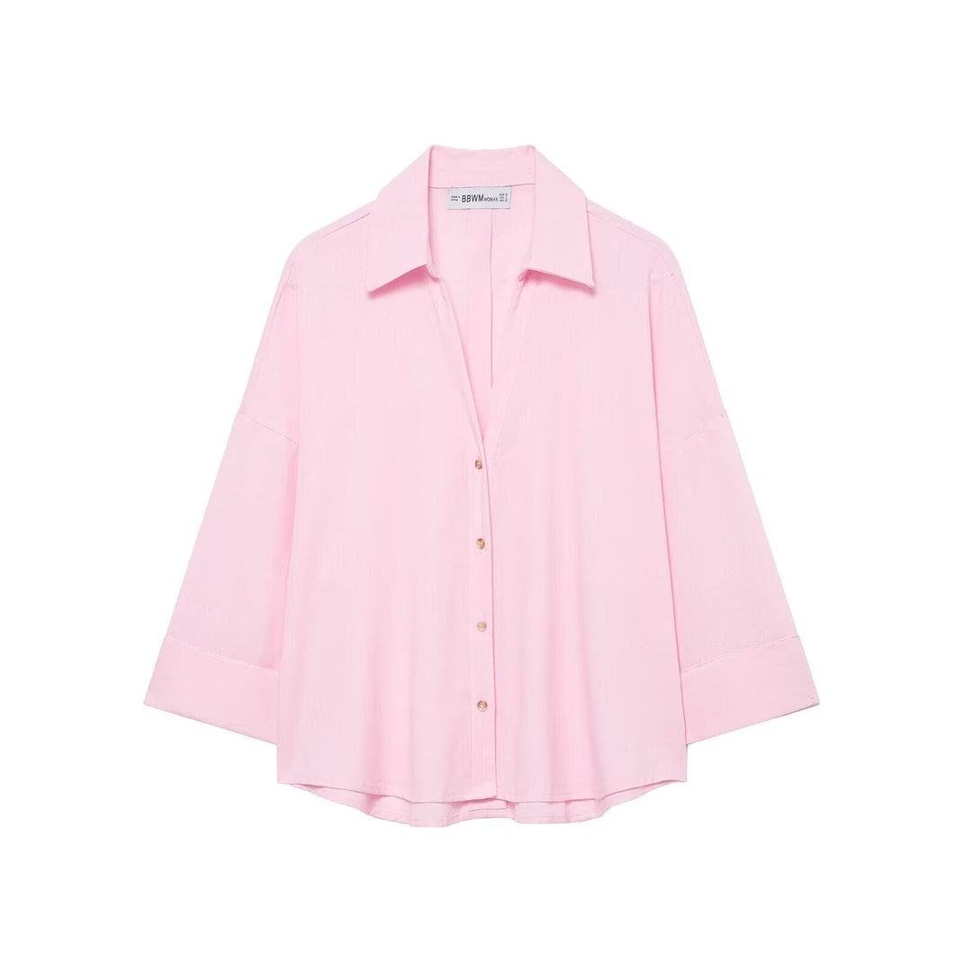 Modern women's oversized button shirt. Relaxed fit long-sleeve blouse for chic everyday style.