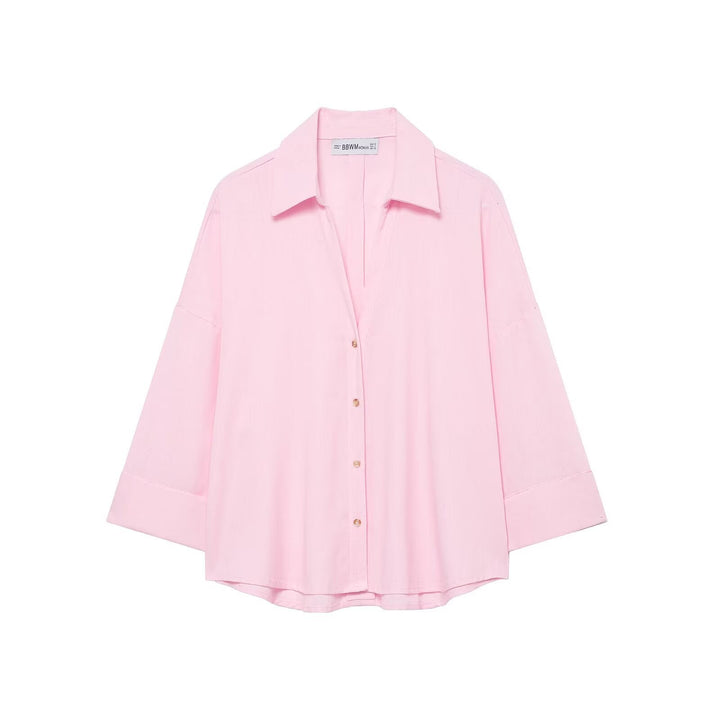 Modern women's oversized button shirt. Relaxed fit long-sleeve blouse for chic everyday style.