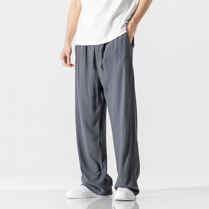 Stylish men's full-length loose fit casual trousers, designed with a comfortable drawstring waist.