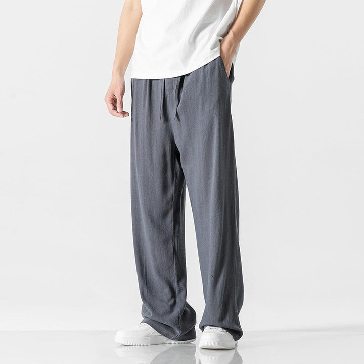 Stylish men's full-length loose fit casual trousers, designed with a comfortable drawstring waist.