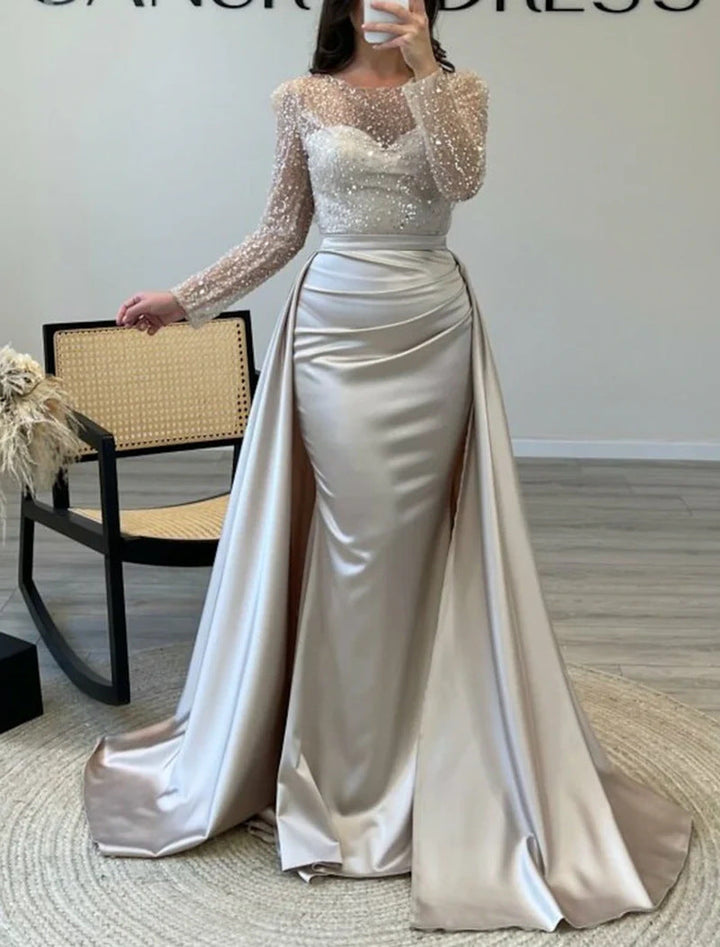Sophisticated women's shimmering long-sleeve formal gown. Elegant evening wear for galas & parties.