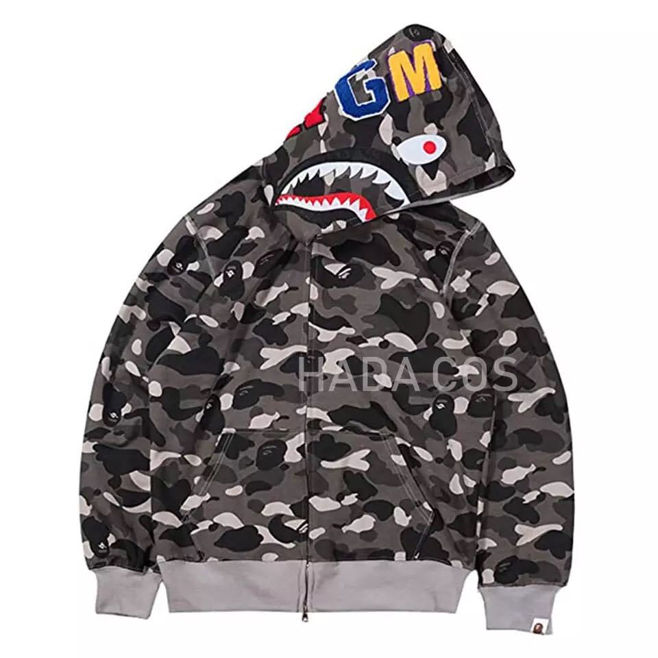 Close-up of women's camouflage print hooded sweatshirt. Trendy activewear fashion top with unique pattern.