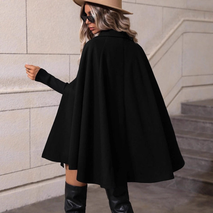 Sophisticated women's double-breasted cape jacket, featuring a tailored silhouette. Ideal for elegant wear.