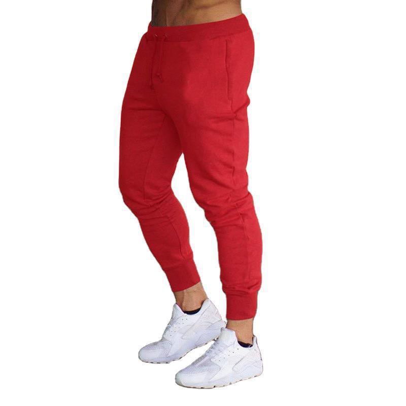 Ribbed ankle cuffs on stylish men's tapered jogging pants, ideal for modern leisure wear.