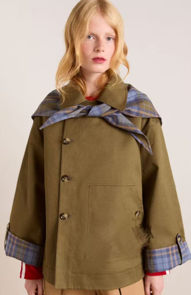 Sophisticated women's long brown trench coat, offering an elegant & chic look for fall and spring outfits.