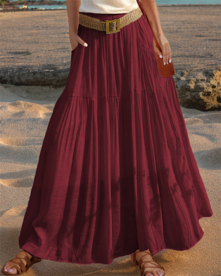 Long pleated skirt for women, offering a flowy silhouette and essential pockets.