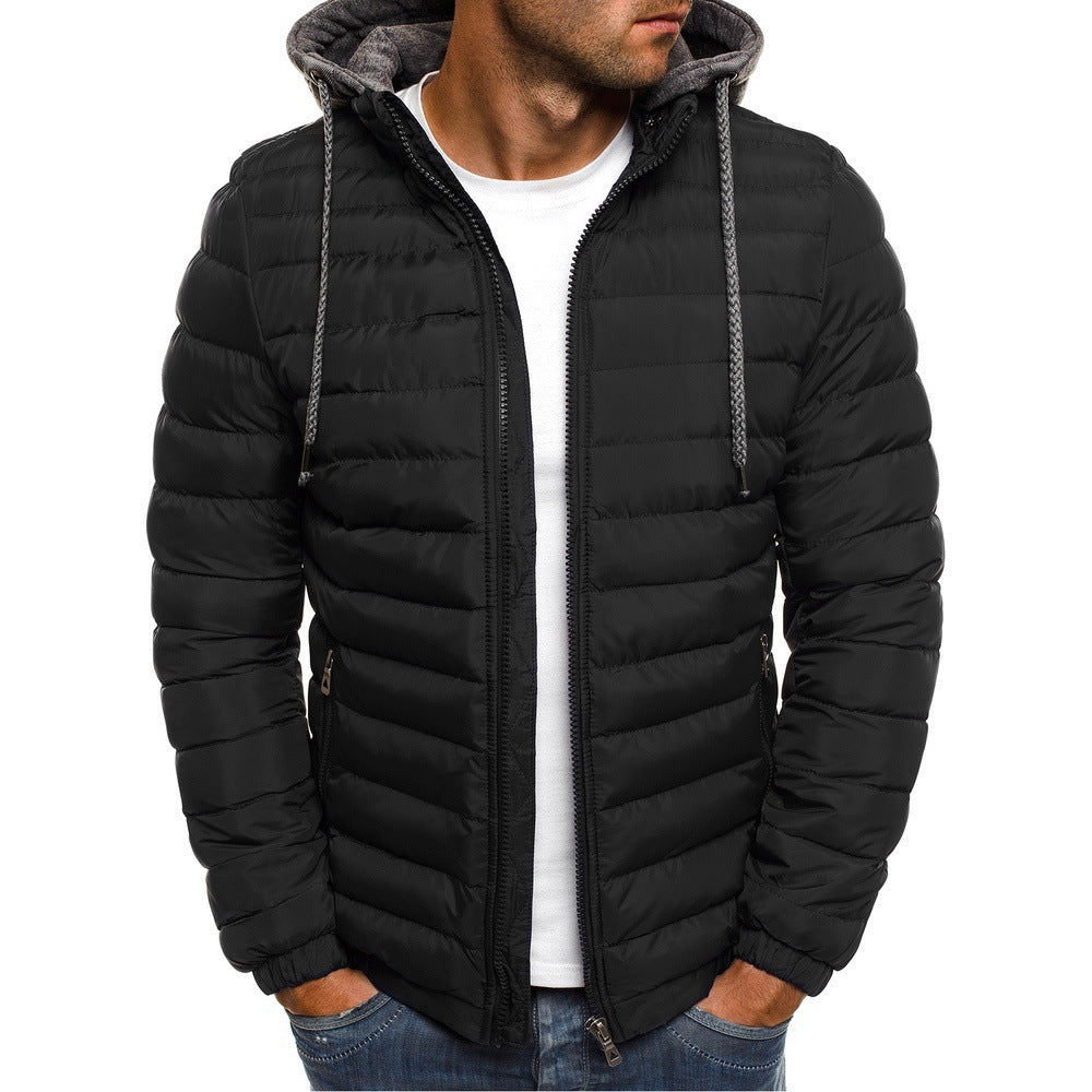 Modern men's quilted outerwear, perfect for layering, offering warmth and style with its removable hood.