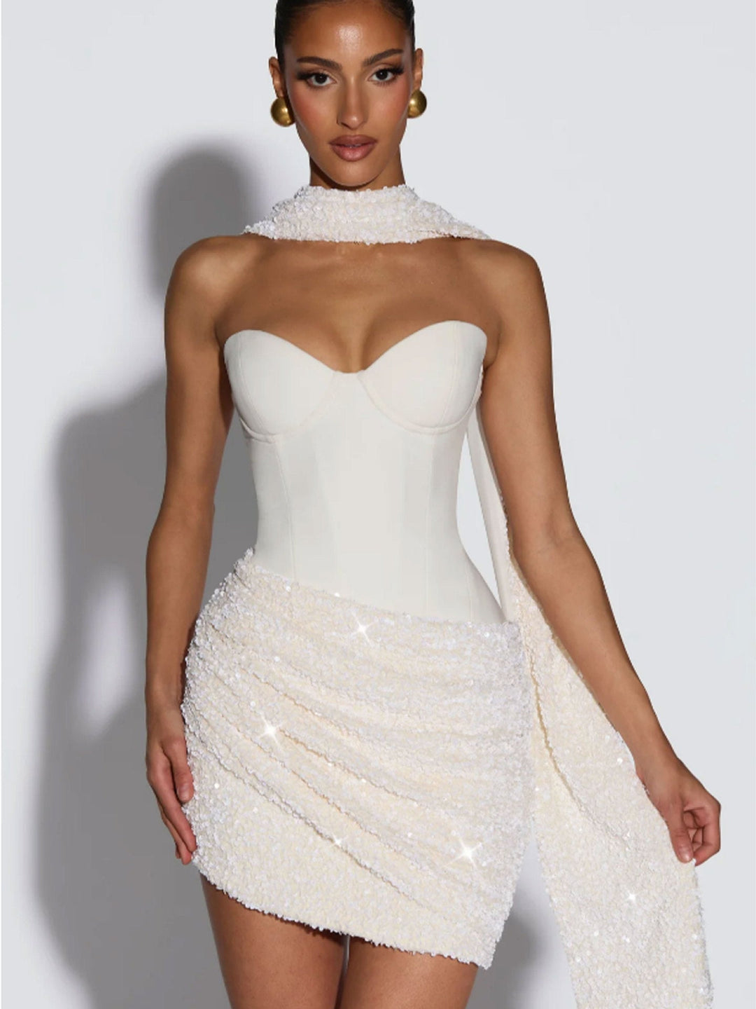Women's glamorous sequin mini bustier dress, a short, figure-hugging party dress that sparkles for an evening out.