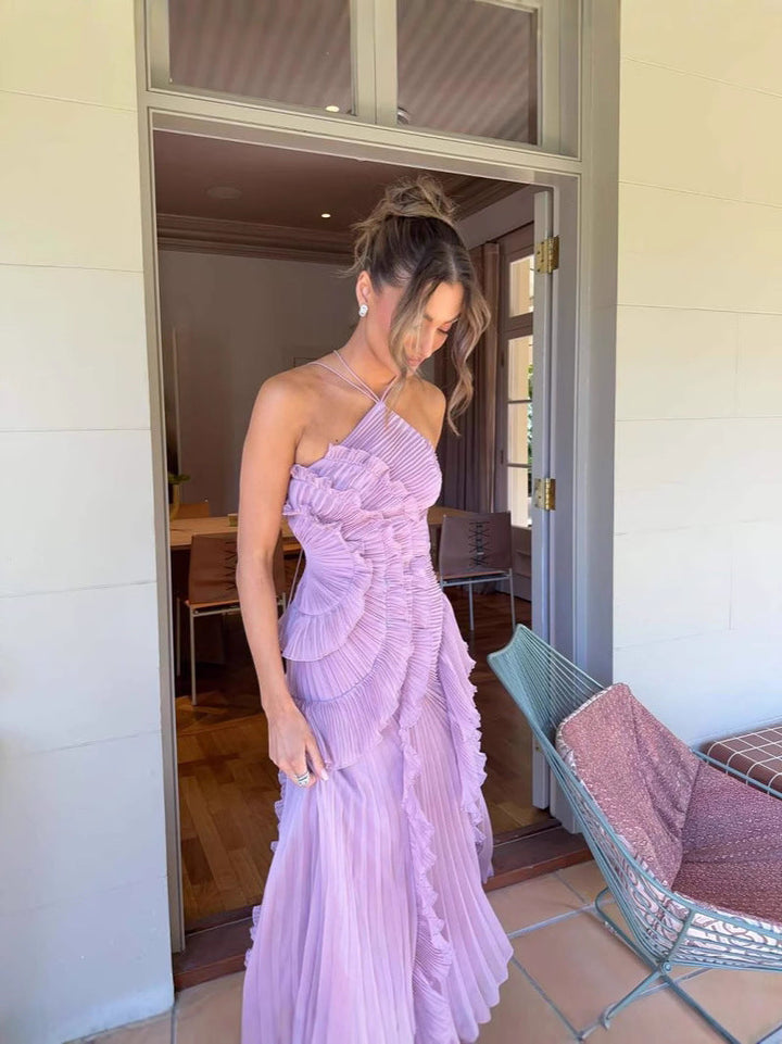 Charming purple flowy ruffle dress for women, ideal for elegant occasions. Sleeveless design.