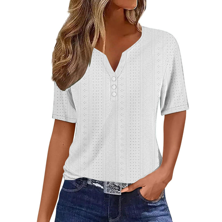 Close-up of button detail & sheer mesh fabric on a stylish women's short sleeve V-neck blouse.