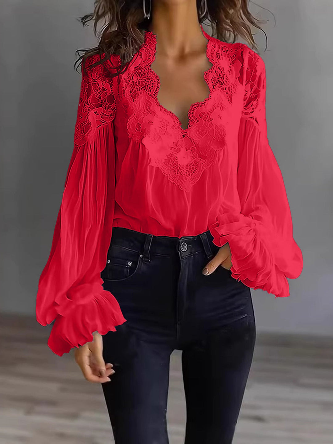 Elegant women's lace blouse, designed with flowing fabric and stylish ruffle-trimmed long sleeves.