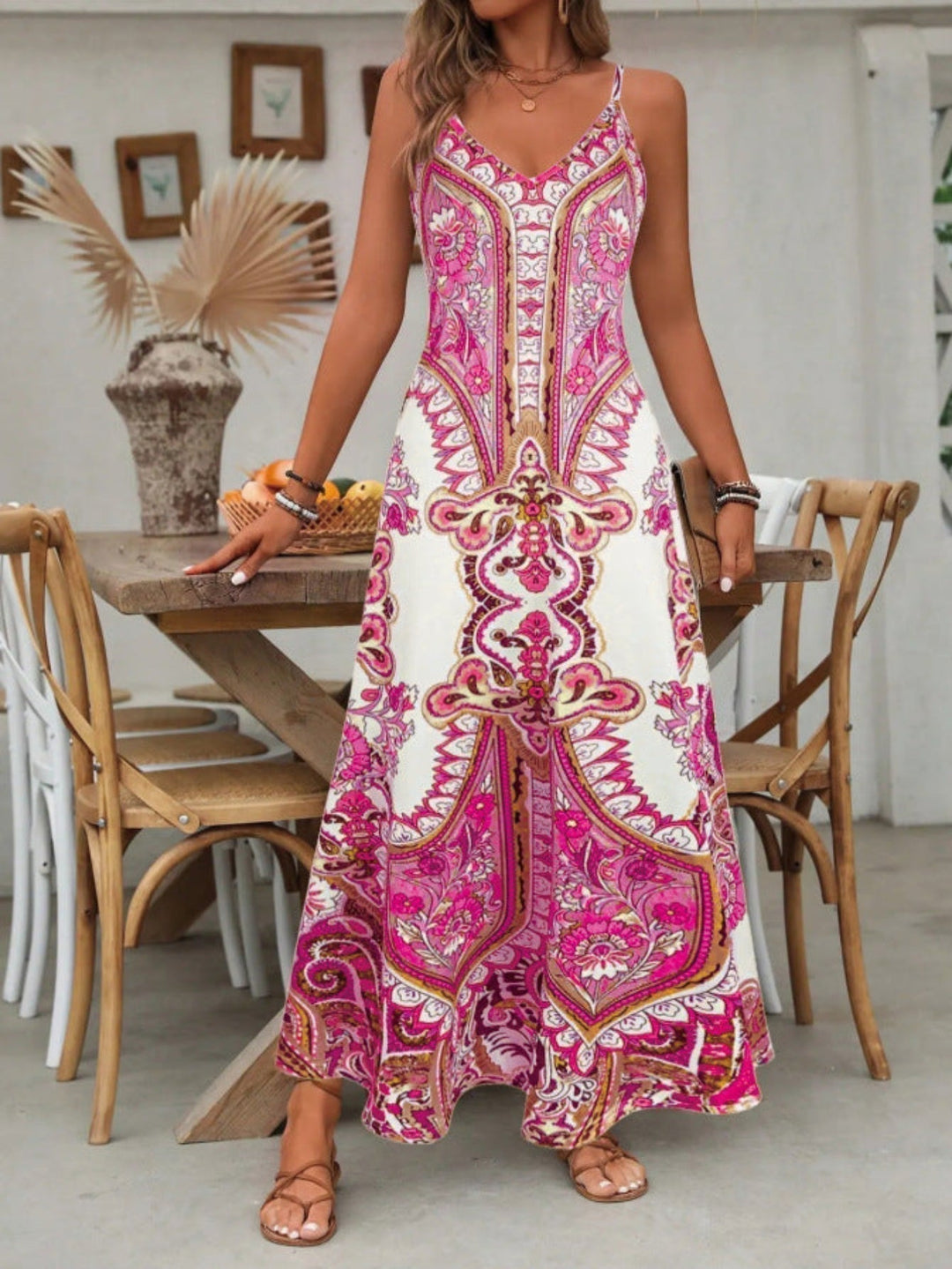 Close-up of a women's boho V-neck maxi dress, showcasing intricate paisley pattern and soft, flowy fabric.