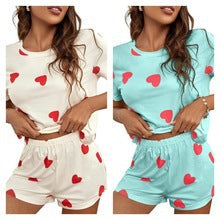 Cozy women's cream heart print loungewear set. Comfortable two-piece pajamas for relaxing at home.