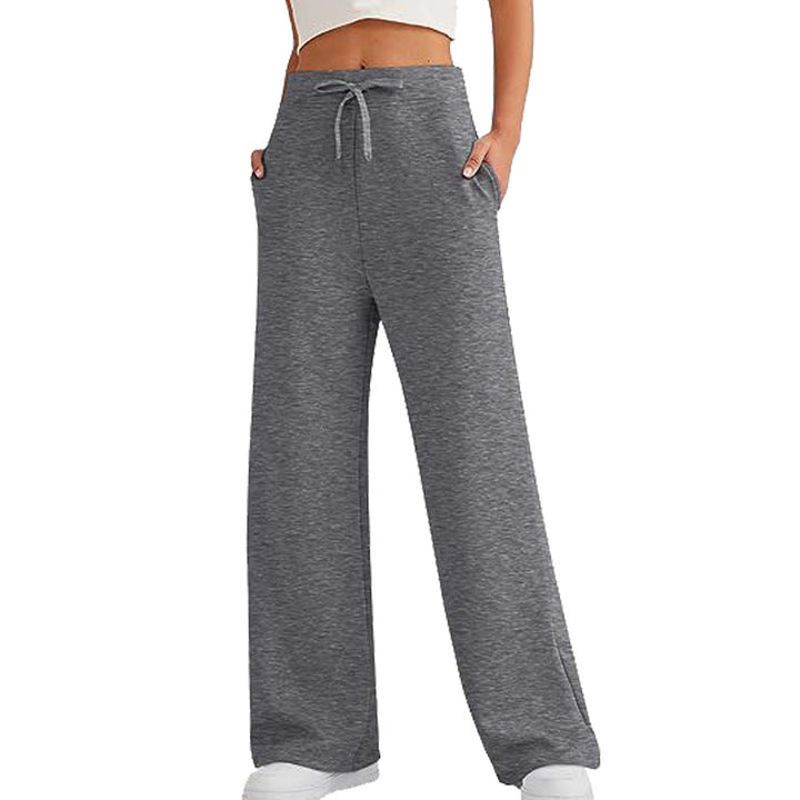 Modern women's relaxed lounge pants, loose fit, with practical pockets for athleisure & home comfort.