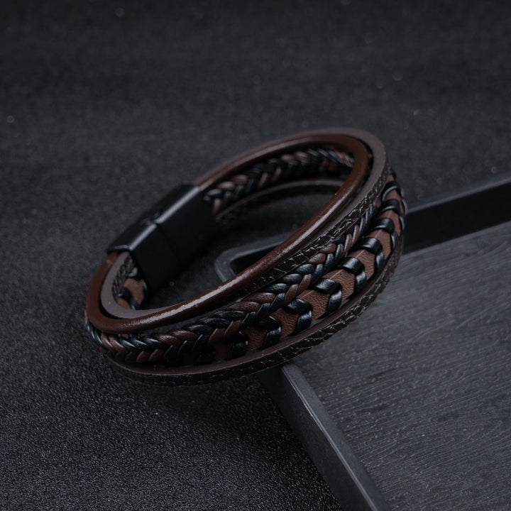 Man fastening a men's braided leather Viking bracelet, highlighting the magnetic clasp.
