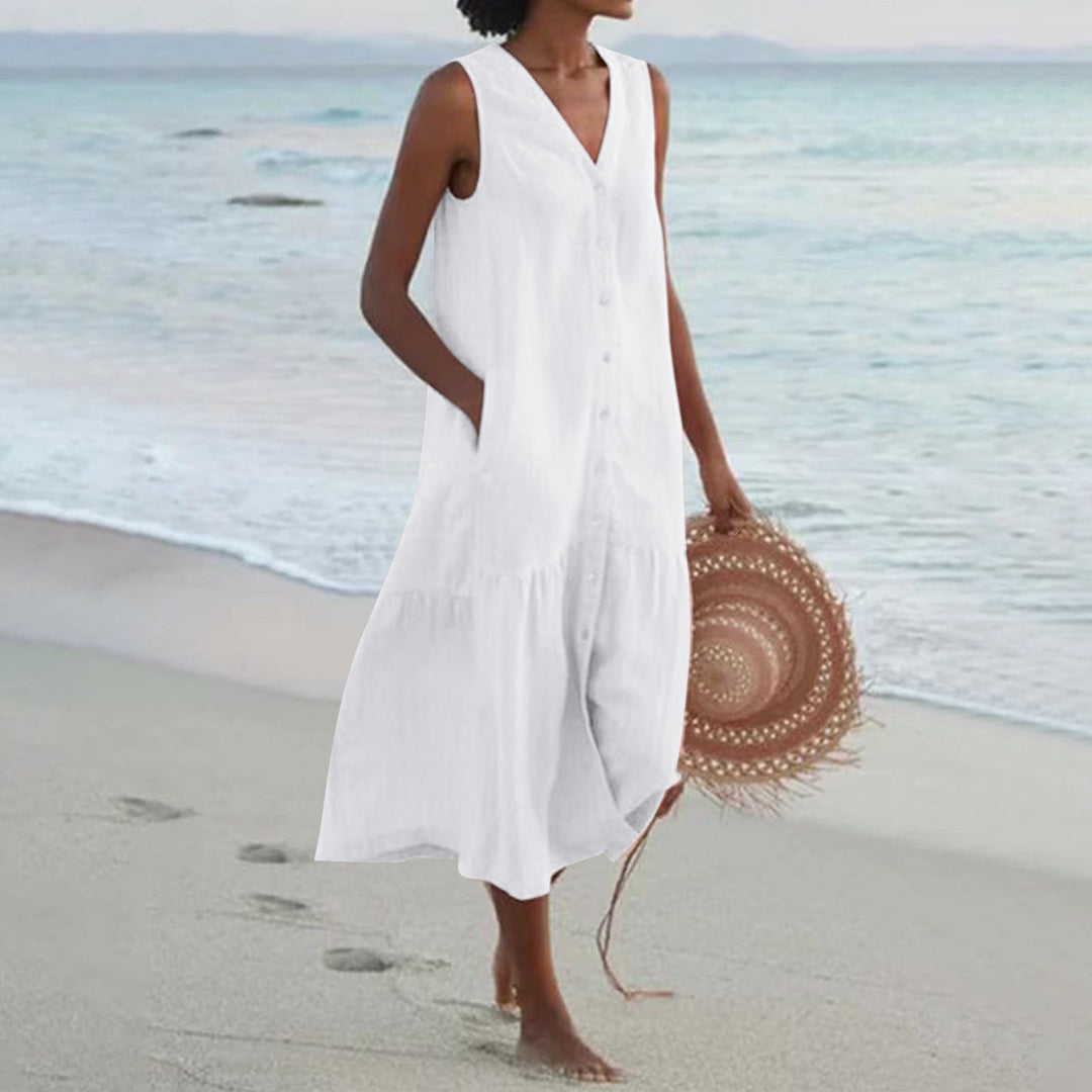 Woman wearing a flattering sleeveless midi summer dress with pockets, perfect for a relaxed everyday look.