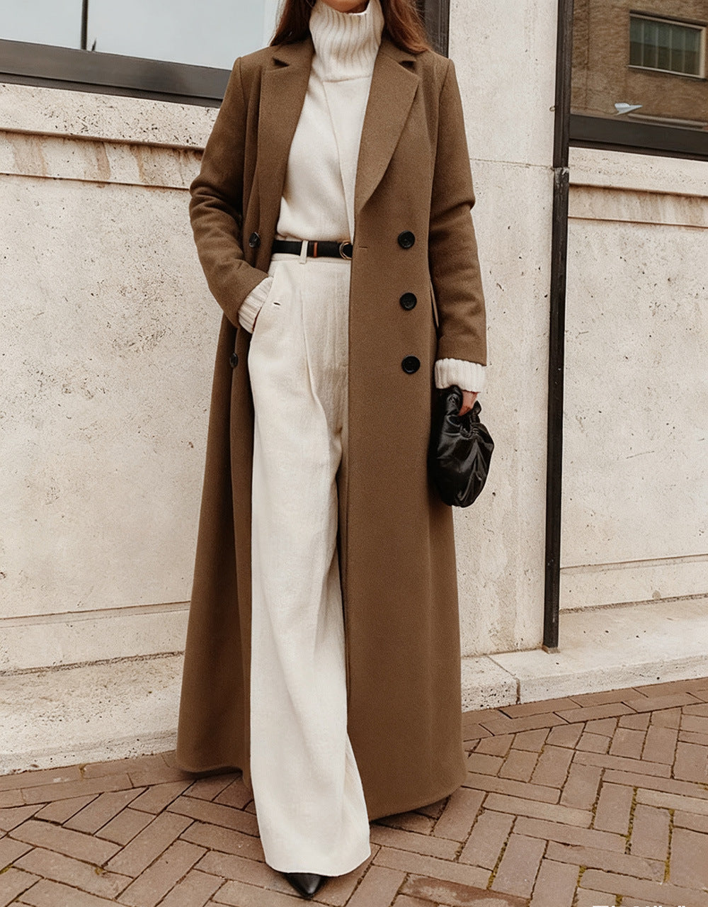 Women's sophisticated long coat, double-breasted front and deep pockets for a classic, elegant look.