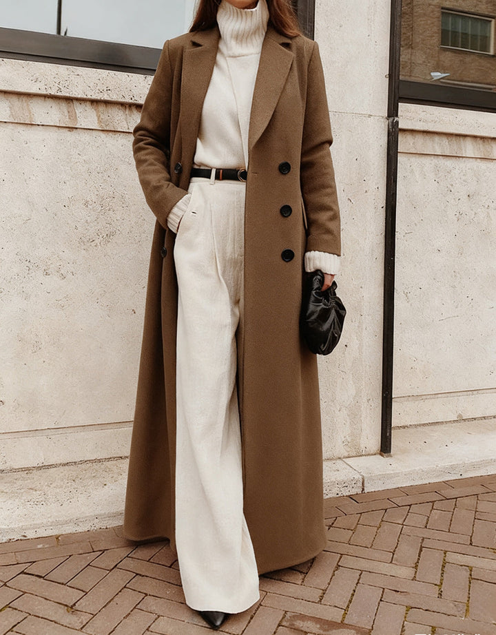Women's sophisticated long coat, double-breasted front and deep pockets for a classic, elegant look.