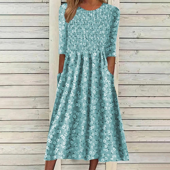 Elegant women's floral midi dress, smocked for comfort & a flattering fit. Ideal for spring and summer wear.