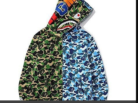 Woman in a dynamic pose wearing a camouflage activewear hoodie. Comfortable & stylish hooded sweatshirt.