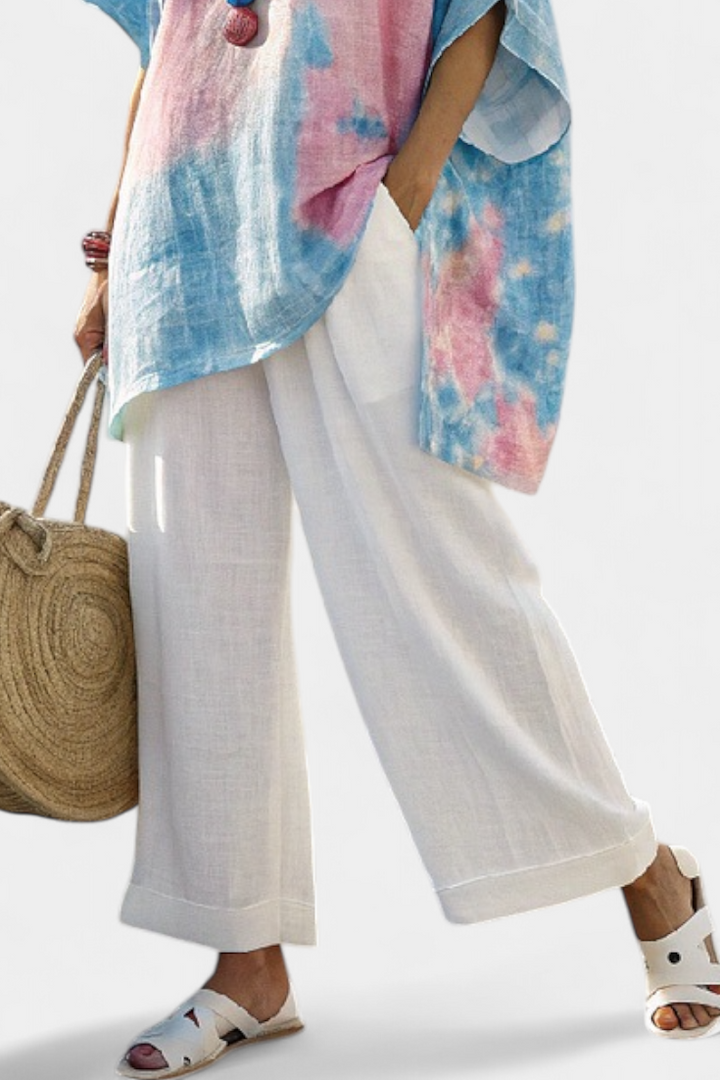 Model wearing a women's flowing top & striped pants set, showcasing its relaxed fit and casual chic summer style.