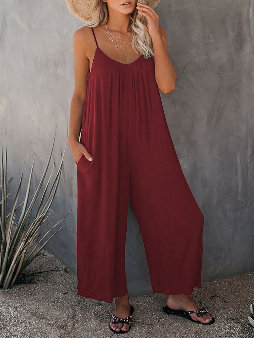 Elegant yet casual women's summer jumpsuit, featuring a plunging neckline, sleeveless design & pockets.