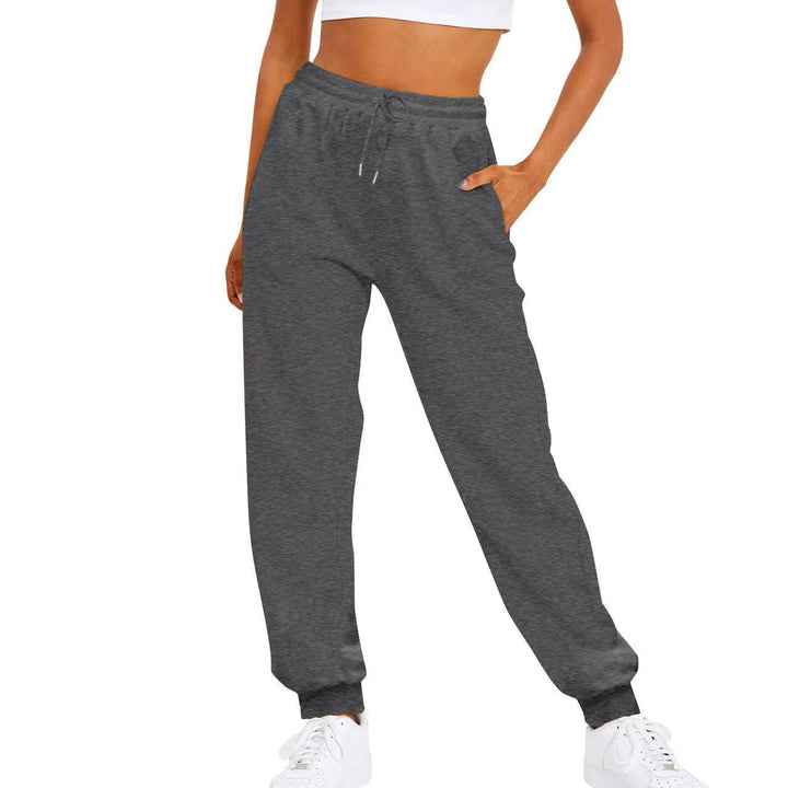 Flexible women's athletic pants with elastic waist & side pockets, allowing freedom of movement for active lifestyles.