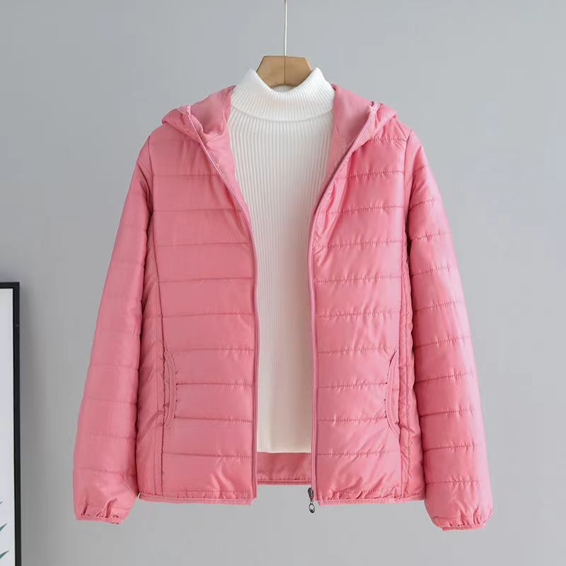 Versatile women's quilted transitional jacket with hood, pockets & cozy lining for spring/fall.
