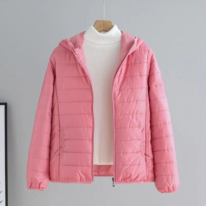 Versatile women's quilted transitional jacket with hood, pockets & cozy lining for spring/fall.