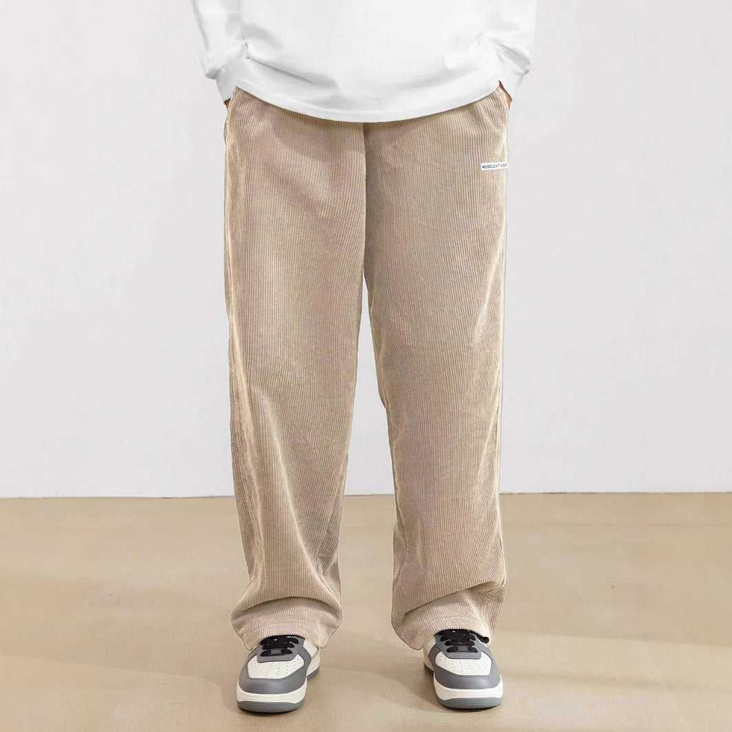 Men's loose fit wide leg pants featuring an elastic waistband & side pockets. Modern, comfortable style.
