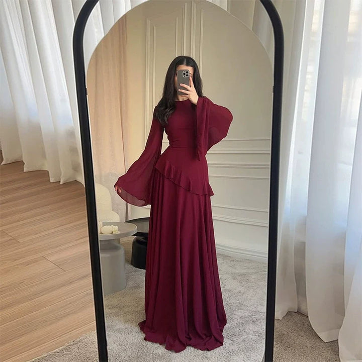 Flowing tiered maxi dress with dramatic bell sleeves, a sophisticated women's gala gown.