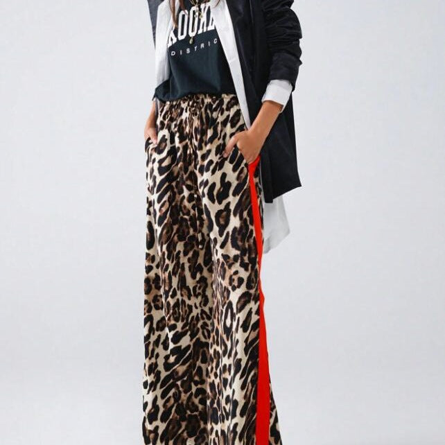 Fashionable women's wide-leg leopard print pants. Loose fit, comfortable & stylish with a modern side stripe detail.
