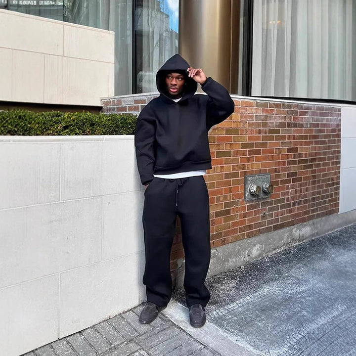 Detailed shot of a men's pullover hoodie, highlighting the drawstring, relaxed fit, and soft fabric. Casual style.