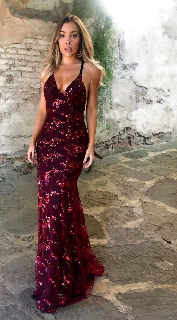 Sophisticated women's sparkling dress. Features a glamorous deep back, high front slit, & elegant silhouette.