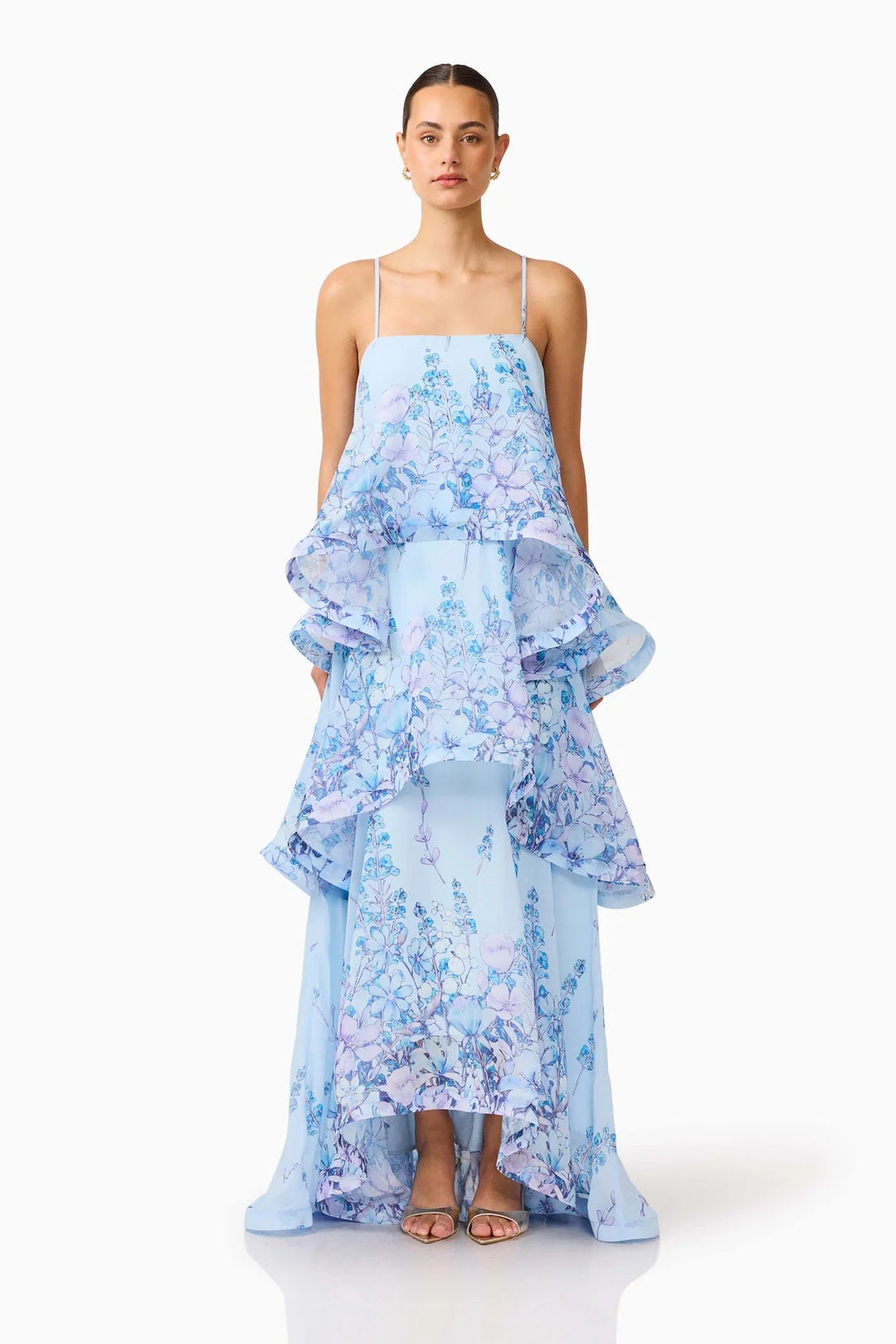 Rear view of a graceful women's ruffle maxi dress, displaying its flowing train and silhouette.