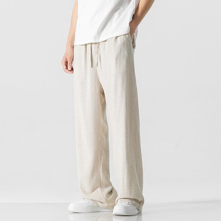 Relaxed loose fit men's pants with an adjustable drawstring waist, great for casual comfort.