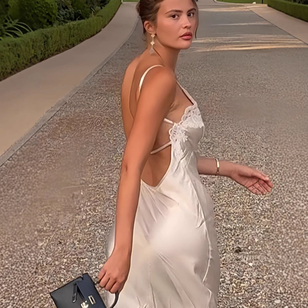 Flowy cream maxi dress with delicate lace trim & thin straps, ideal for evening gowns or parties.