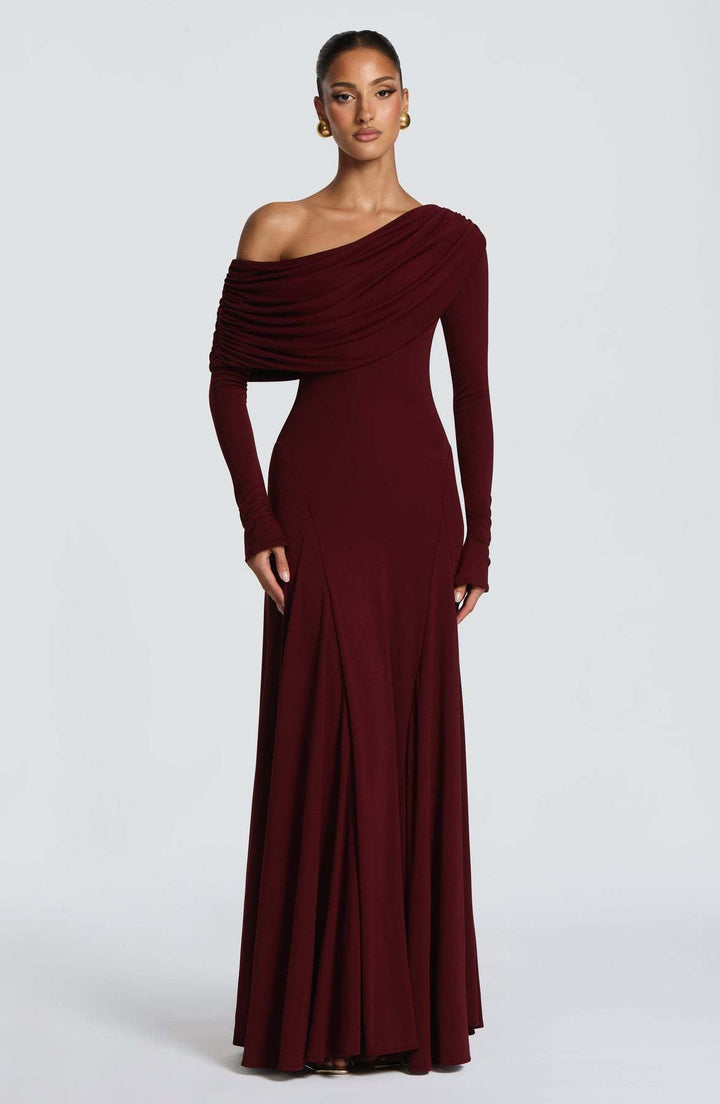 Beautiful women's special occasion maxi dress with long sleeves and elegant asymmetrical draping for a chic look.