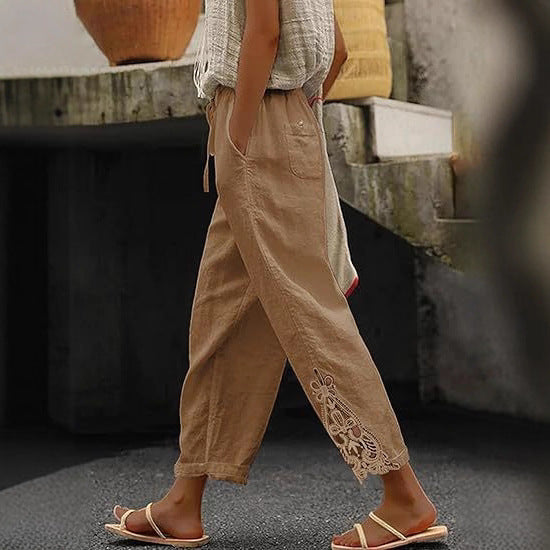 Comfortable women's trousers with adjustable drawstring waist and elegant side embroidery detail.
