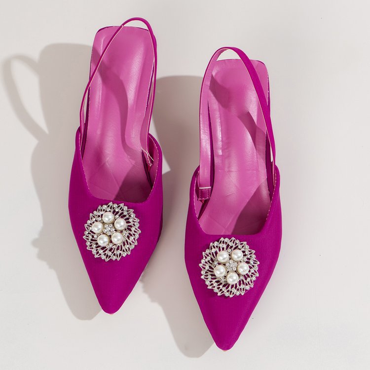 Close-up of elegant women's slingback pumps showcasing pearl embellishments and a refined pointed toe design.