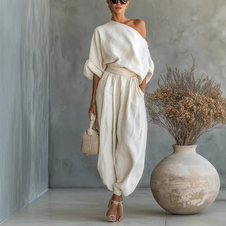 Fashionable cream asymmetrical neck jumpsuit, a comfortable loose fit one-piece for women's summer versatility.