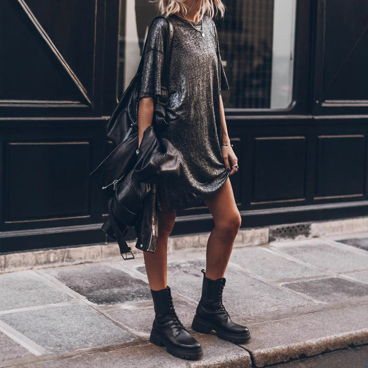 Oversized women's black glitter dress with a shimmering finish and elegant side slit, offering a relaxed yet stylish fit.