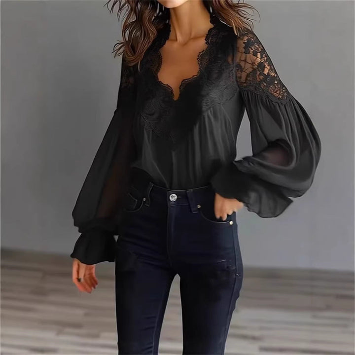 Fashionable women's lace blouse with cascading ruffle sleeves, ideal for a sophisticated spring look.