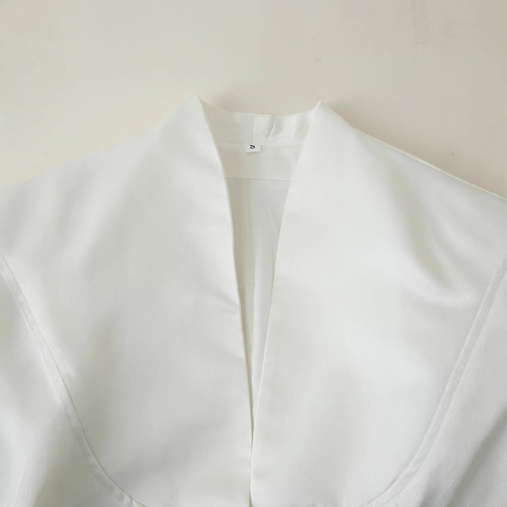 Women's crisp white tailored blazer with a classic fit, exuding professional elegance.