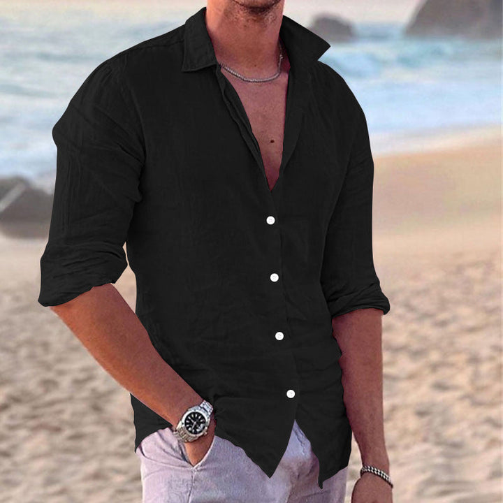 Neatly folded men's casual button-down shirt. Ready for summer travel, vacation wear, and beach style.